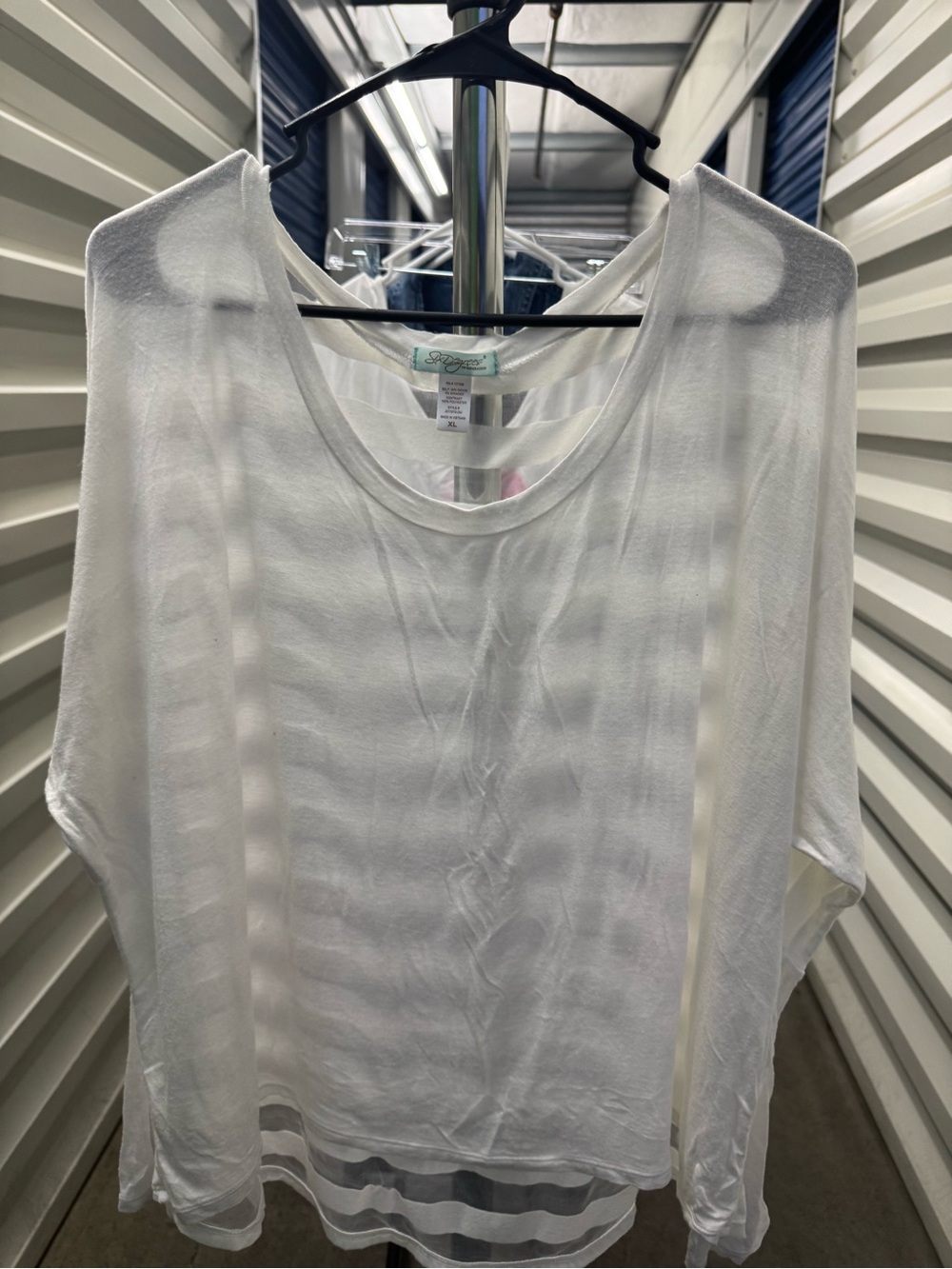 Long sleeve cream color blouse with netting in the back. Size XL